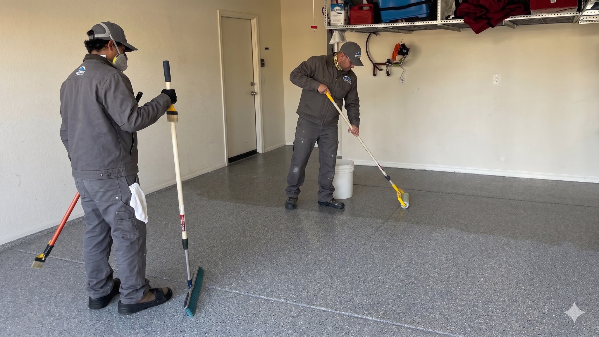 Professional garage floor coating installers applying epoxy in Hutto Texas
